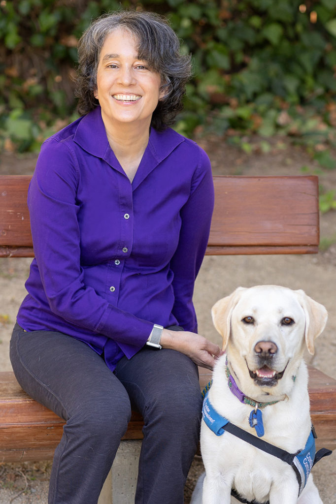 Photo of Thida Cornes and her service dog.
